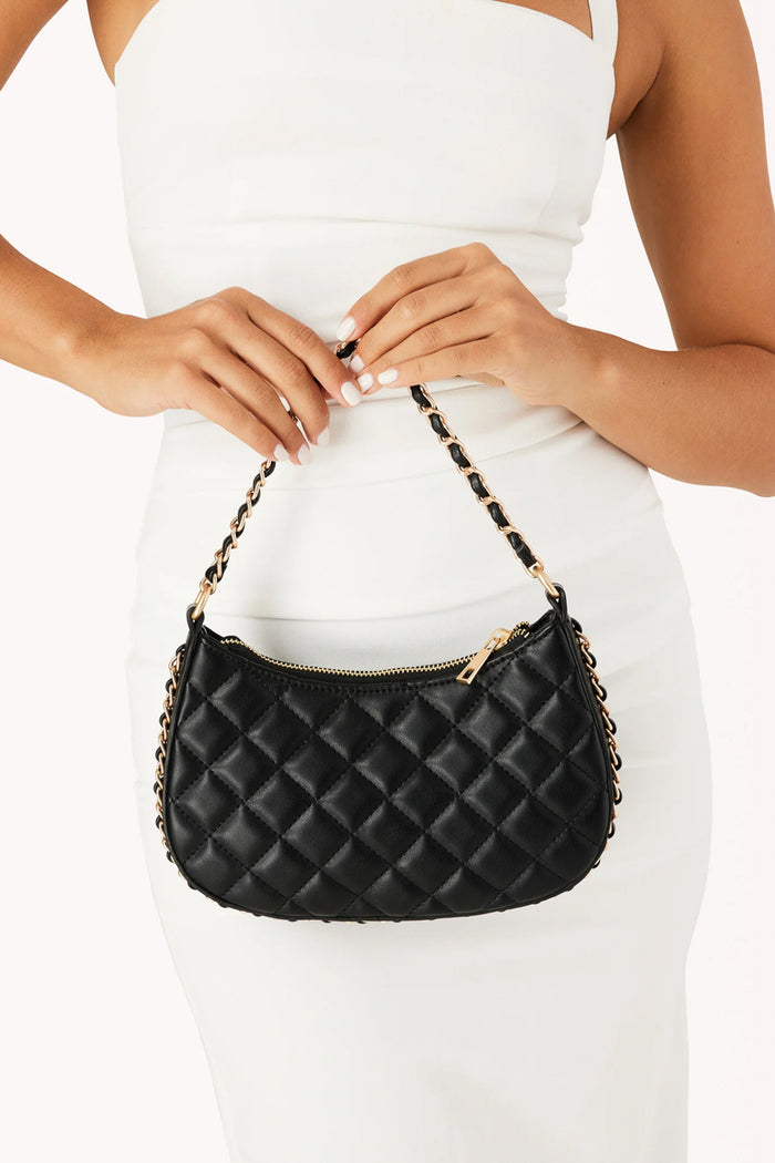 try on view | black quilted purse with gold hardwear chain border and strap