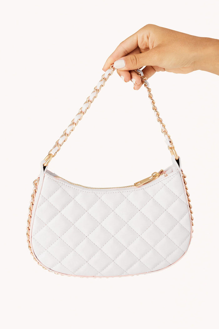 held view | white quilted purse with gold hardwear chain border and strap