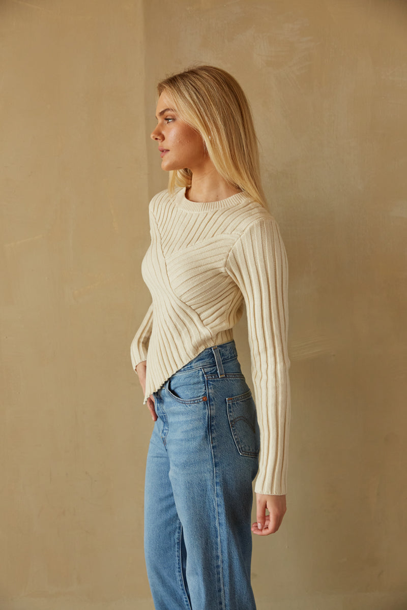 https://www.shopamericanthreads.com/cdn/shop/files/bailey-cream-long-sleeve-ribbed-knit-hankercheif-sweater-winter-essentials-trendy-sweater-boutique-levis-ribcage-straight-ankle-jean-in-the-middle-light-wash-pants-013.jpg?v=1699394969&width=800