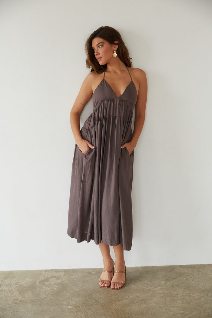 A lady in a flowy maxi dress from American Threads, ideal for summer vacation outfits and trendy dresses.