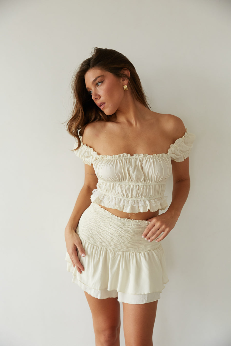 A woman in a ruffled crop top and skirt from American Threads, perfect cute top and short dress look.