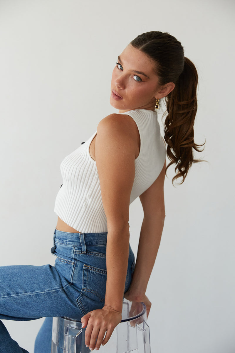 A girl in a white corset top and trendy jeans from American Threads, perfect for fall clothes and outfits.