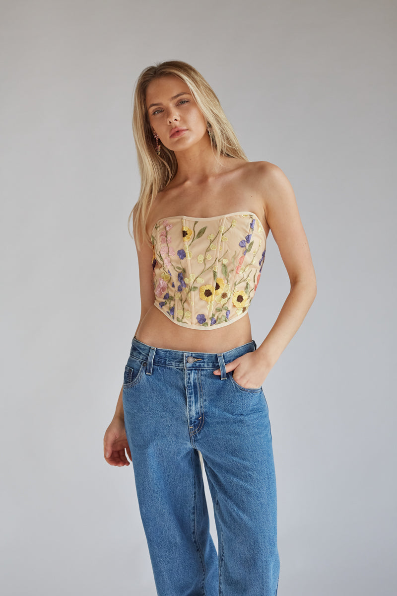 https://www.shopamericanthreads.com/cdn/shop/files/marigold-strapless-floral-embroidered-lace-corset-crop-top-levi_s-baggy-dad-denim-jeans-spring-outfit-inspo-10.jpg?v=1706035763&width=1200