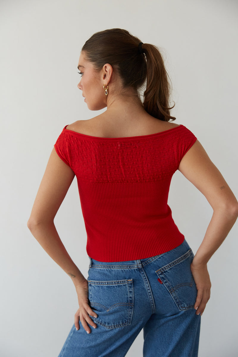 Back view of a woman in a red cute crop top and trendy jeans from American Threads, perfect for fall outfits.