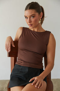 A girl in a brown cute top and black mini skirt from American Threads, perfect for fall outfits and dresses.