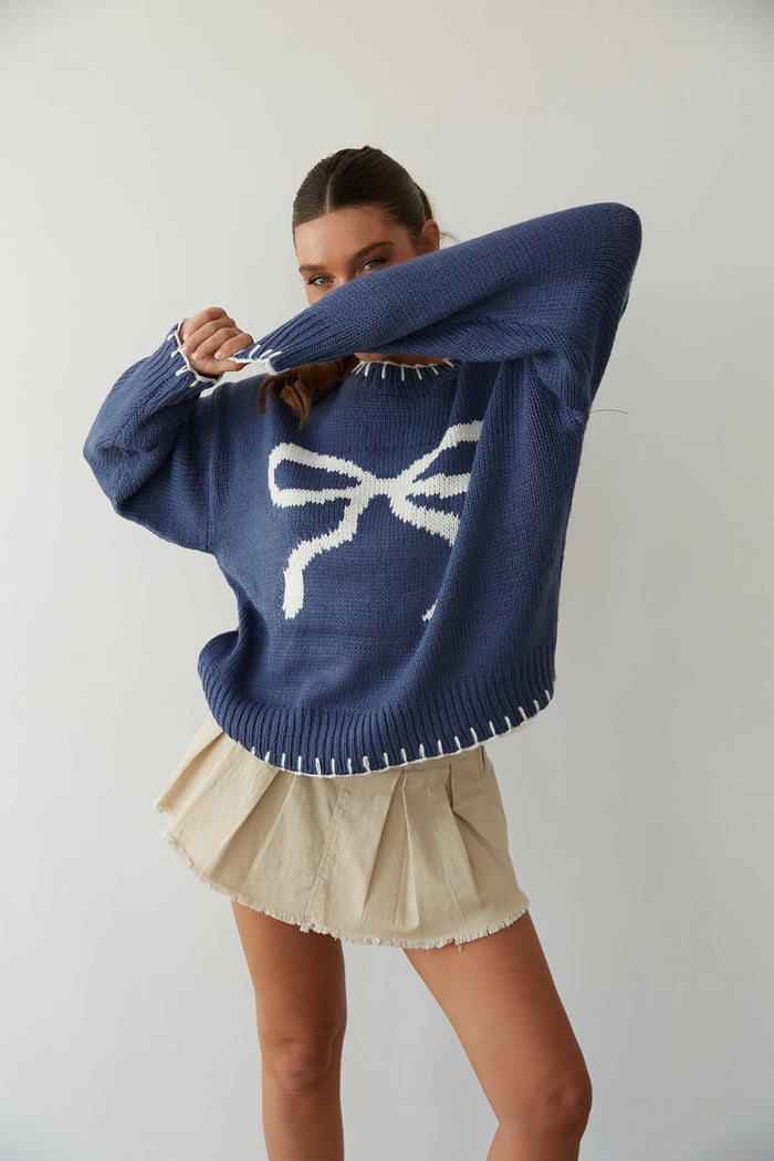 front view | blue chunky knit sweater with white bow print | coquette sweater